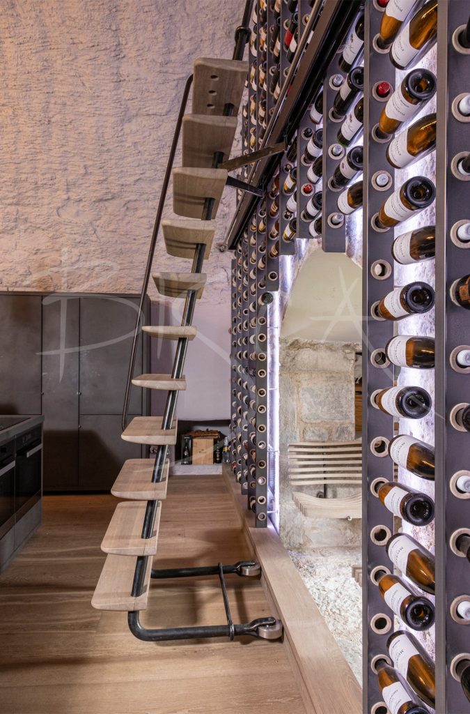 Illuminated-Bespoke-wine-wall-with-sliding-ladder-at-Belvelly-Castle