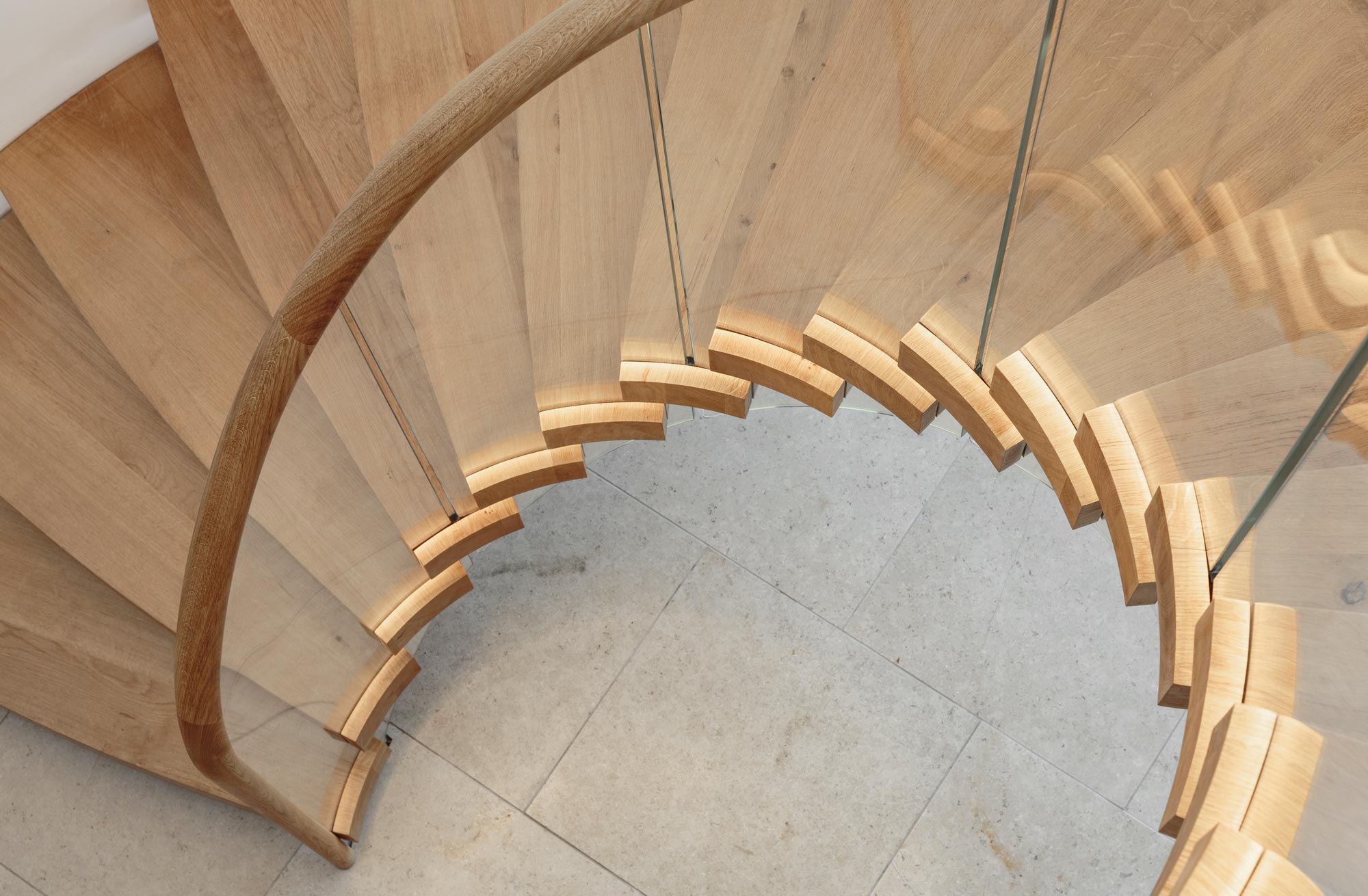 Helical Bisca staircase with stair lighting under the handrail