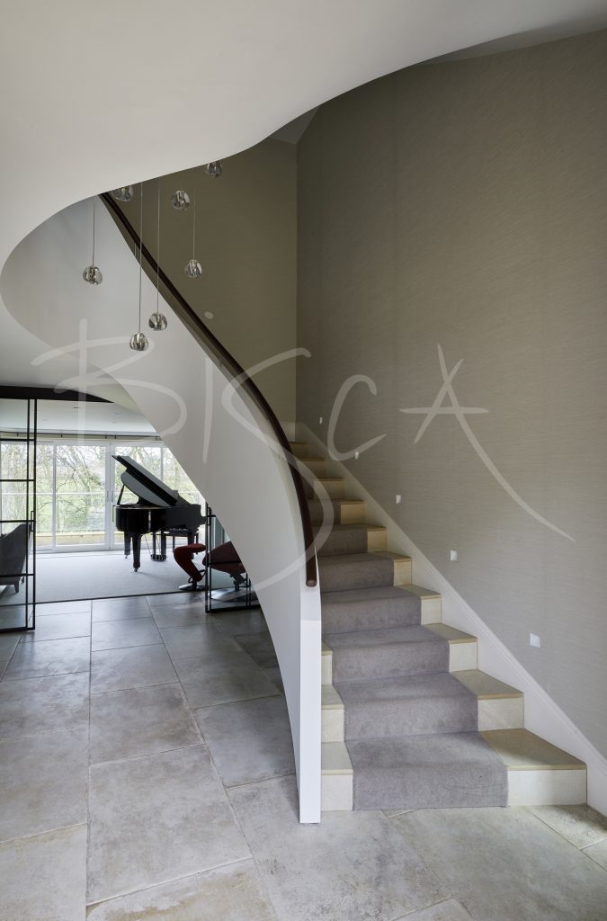 Stunning Curved Staircase With Stone Treads